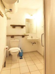 a bathroom with a toilet and a sink at Villa Hermes - Luxury Villa Paros in Kampos Paros
