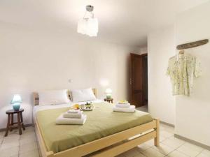 a bedroom with a large bed with towels on it at Villa Hermes - Luxury Villa Paros in Kampos Paros