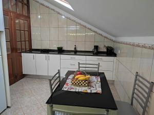 a kitchen with a table with fruit on it at Casa Câmara in Arco da Calheta