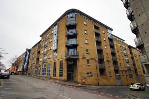 a large brick building on the side of a street at Bright 1Bedroom Apartment, Central Location with Balcony in Bristol