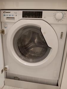 a washing machine with its door open in a room at Gregorio Marañón Apartment4 in Madrid