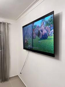 a flat screen tv hanging on a wall at Flor de lirio in Juan López