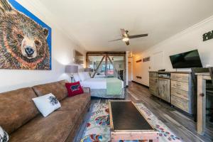 a living room with a couch and a bed at Striking King Studio w/Partial Lake View #242 at Donner Lake Village in Truckee