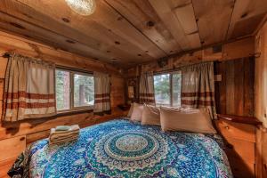a bedroom with a bed in a log cabin at Two Bedroom Cabin Used To Belong to Deborah Winger! in Ruidoso
