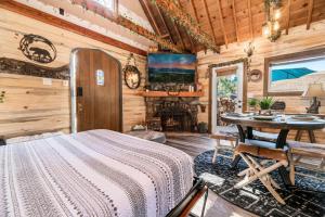 um quarto com uma cama e uma mesa num camarote em Hansel and Gretel Cottage em Big Bear City