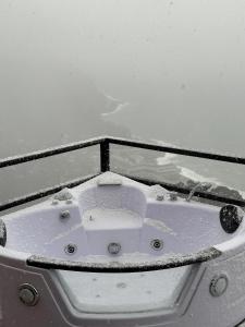 a bath tub on a boat covered in snow at Panorama Sarpi in Batumi