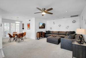 a living room with a couch and a table at Keith Haring Inspired 2BD Deauville Condo - A Ryson Property in Palm Springs