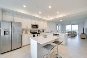 a kitchen with white cabinets and a large kitchen island at Breezy Ave Maria Condo with Golf Course On-Site! in Harker