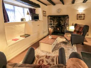 a living room with a couch and a fireplace at How Head Cottage in Ambleside