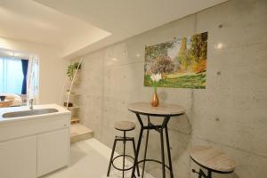 a kitchen with two stools and a painting on the wall at Toyocho SA-KU-RA - Vacation STAY 44020v in Tokyo