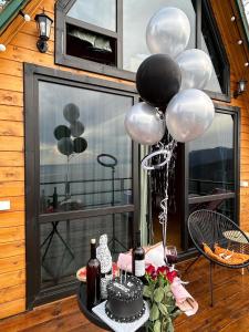 a party with balloons and a cake on a table at Panorama Sarpi in Batumi