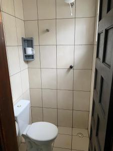 a small bathroom with a toilet and a shower at Hotel Vila de São Vicente in São Vicente
