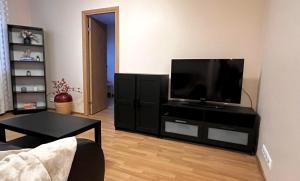 a living room with a flat screen tv on a stand at Struve Apartment City Centre in Tartu