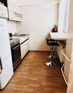 a small kitchen with a sink and a desk at Struve Apartment City Centre in Tartu