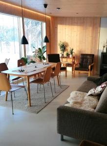 a living room with a table and a couch at Ilveslinna in Laukaa