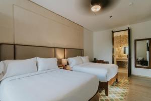 Postel nebo postele na pokoji v ubytování Kahal Hotel - Paseo Montejo