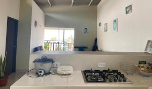 a kitchen with a stove top with a pot on it at CASA GRAU - ZORRITOS in Caleta Grau