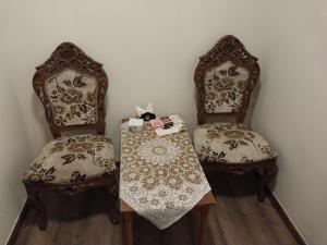 two chairs with a table inbetween them with a tableablish at KING Hostel in Center in Baku