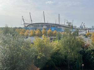 a baseball stadium with a building in the background at Balcony Apartment - Views Of Etihad Stadium - Near CoOp Live Arena in Manchester