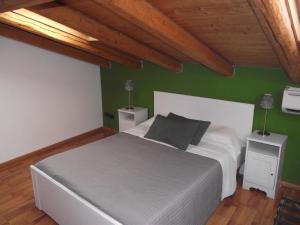 1 dormitorio con cama blanca y paredes verdes en XX Miglia rooms & apartments en Catania