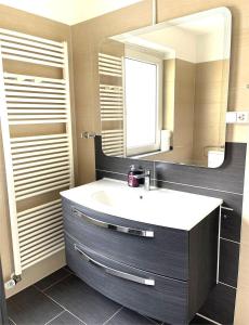a bathroom with a sink and a mirror at Easy to Düsseldorf Messe, 2-bedroom Apartment with kitchen and garden in Duisburg