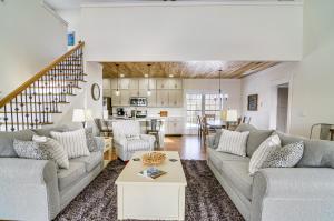 a living room with two couches and a table at Dale Hollow Cottage with Covered Porch and Lake Views! in Frogue