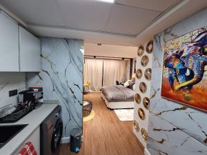 a room with a kitchen and a living room at PATAIRBNB in Ras al Khaimah