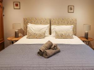 łóżko z pluszakiem leżącym na nim w obiekcie Mistletoe Cottage w mieście Bamburgh