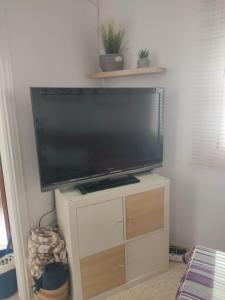 a large flat screen tv on a stand in a room at Apartamento Lerele in El Bosque