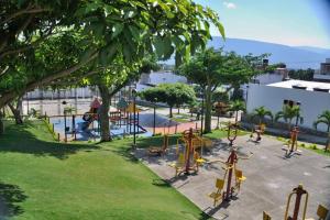 a playground in a park with trees and equipment at Chic 2Bedroom in Cúcuta in Villa del Rosario