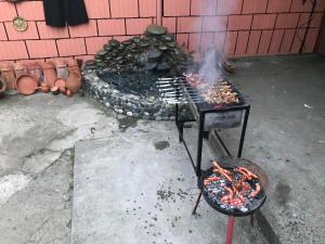 a grill with a bunch of food on it at ALEXANDRE’s House in Kobuleti