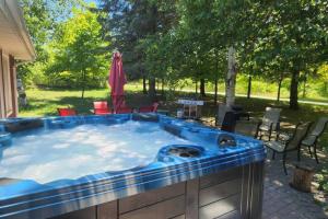 a large jacuzzi tub in a backyard at Prince Edward County~Water View~FREE Pontoon Boat~Sandbanks Pass in West Lake