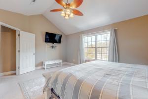 a bedroom with a bed and a ceiling fan at Bare Assets in Pigeon Forge