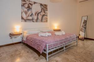 a bedroom with a bed with two pillows on it at I Papaveri - City center Flat - Leonardo Accademy - MXP - Lakes in Sesto Calende