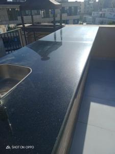 a counter top with a sink on top of a building at Nice Studio on the Roof in Sheikh Zayed