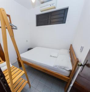 سرير أو أسرّة في غرفة في Mansão Guará - com piscina, salão de jogos, churrasqueira e cozinha