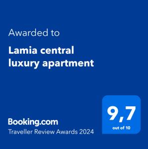 a blue sign with the text awarded toiane central luxury apartment at Lamia central luxury apartment in Lamía