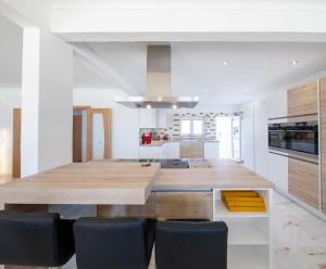 kuchnia z dużym drewnianym stołem i krzesłami w obiekcie Villa Casa Colina - Algarve - 7 Bedrooms, Private location w mieście Estoi