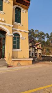 a yellow building on the side of a street at Patriata Luxury Suits in Murree