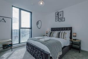 a bedroom with a large bed and a large window at Stunning 2-Bed Premium Apartment - Free WI-FI in Preston