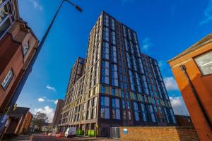 a tall building on a city street at Stunning 2-Bed Premium Apartment - Free WI-FI in Preston