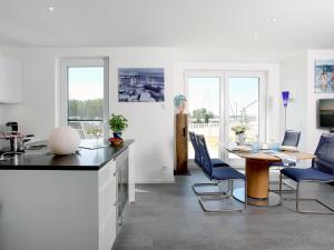 a kitchen with a table and chairs and a dining room at Ferienhaus am Yachthafen in Peenemünde in Peenemünde