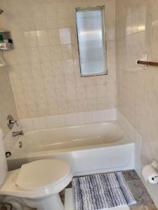 a bathroom with a white tub and a toilet at 1161 Studio 3 Miami in Miami