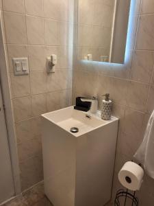 a white sink in a bathroom with a mirror at 1161 Studio 3 Miami in Miami