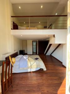a bedroom with a large bed in a loft at Floré Hotel Boutique Cuenca in Cuenca