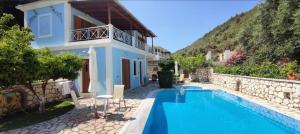 a villa with a swimming pool and a house at AGIOS NIKITAS DOLPHINS in Agios Nikitas +15 photos