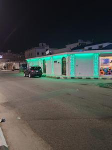 a building with blue lights on the side of a street at منتجع الريحانه فله رقم 1 in Taif