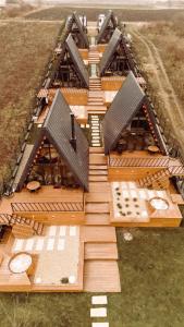 an overhead view of a building with wooden floors at A-BY THE LAKE - PRIVATE A FRAME VILLAS in Căciulaţi