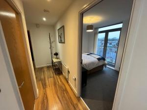 a bedroom with a bed and a large mirror at Central Darlington Large Penthouse Apartment in Darlington