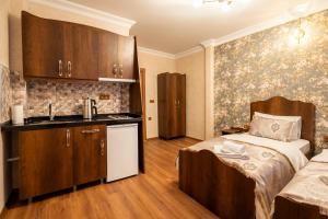 a bedroom with a bed and a sink in a room at Nasip House in Istanbul